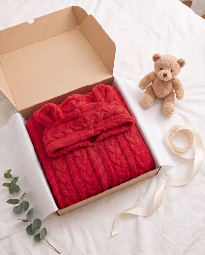 TEDDY Cozy Bear Onesie in Red folded in a gift box with tissue paper and a small teddy bear